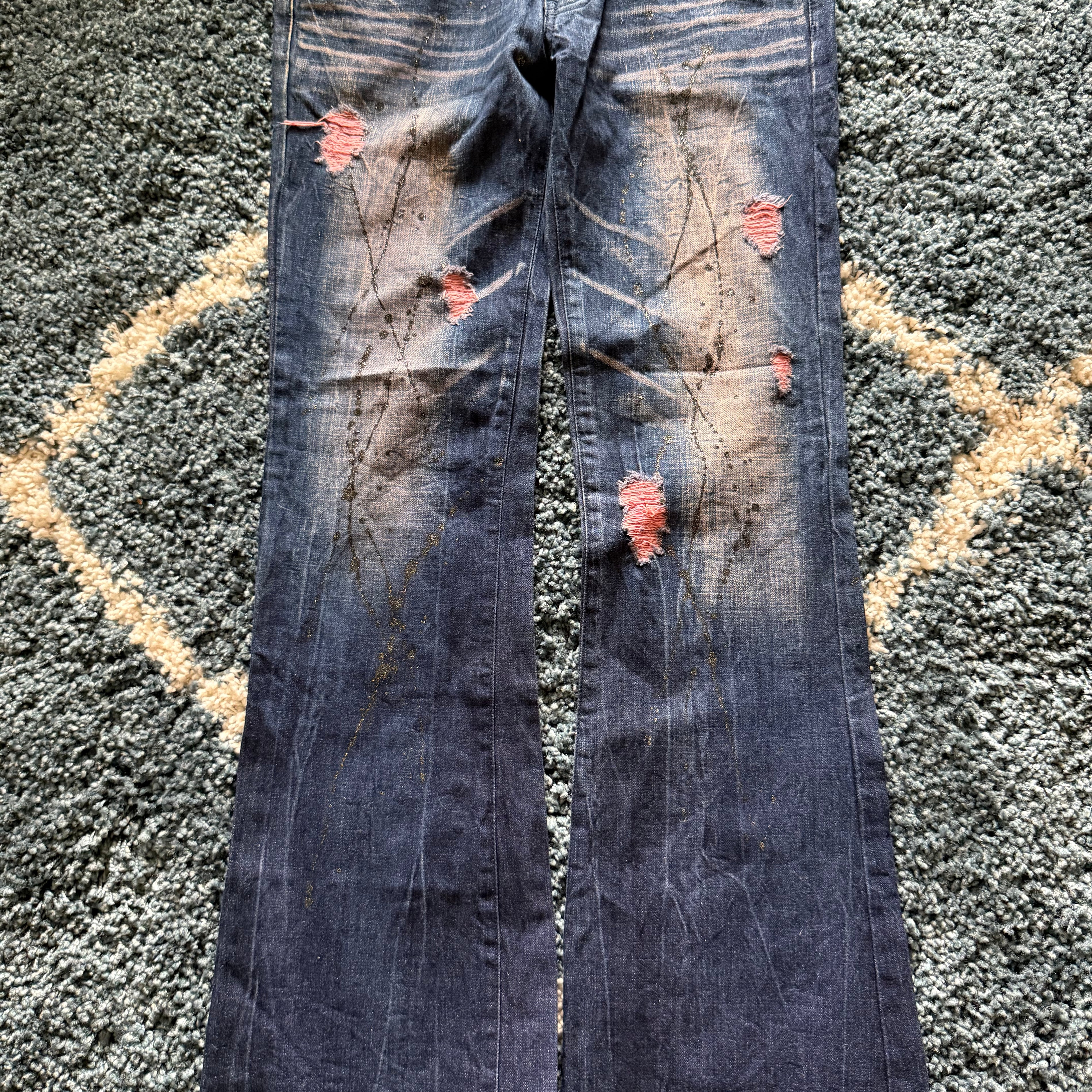 Glad news splattered distressed flared jeans