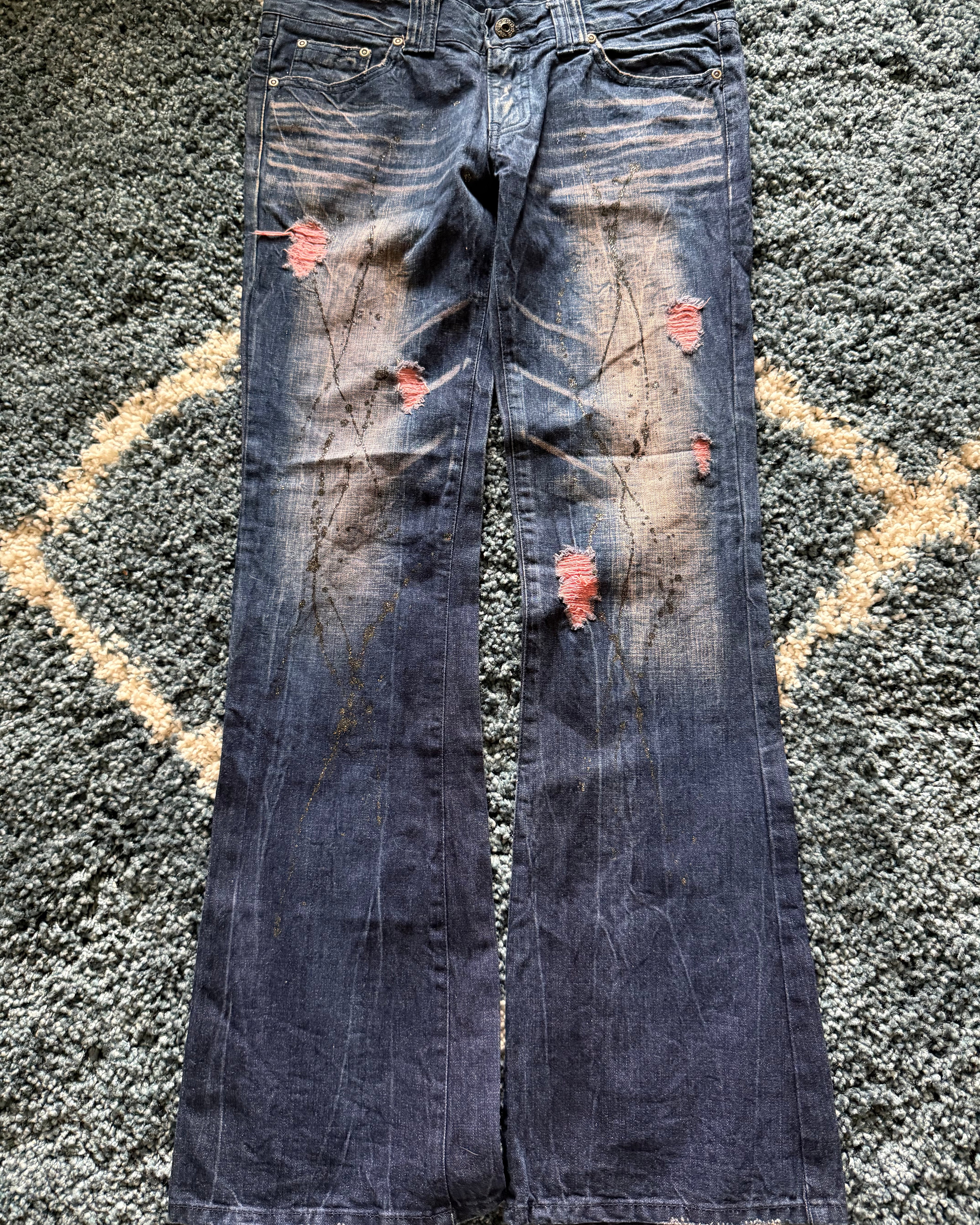 Glad news splattered distressed flared jeans
