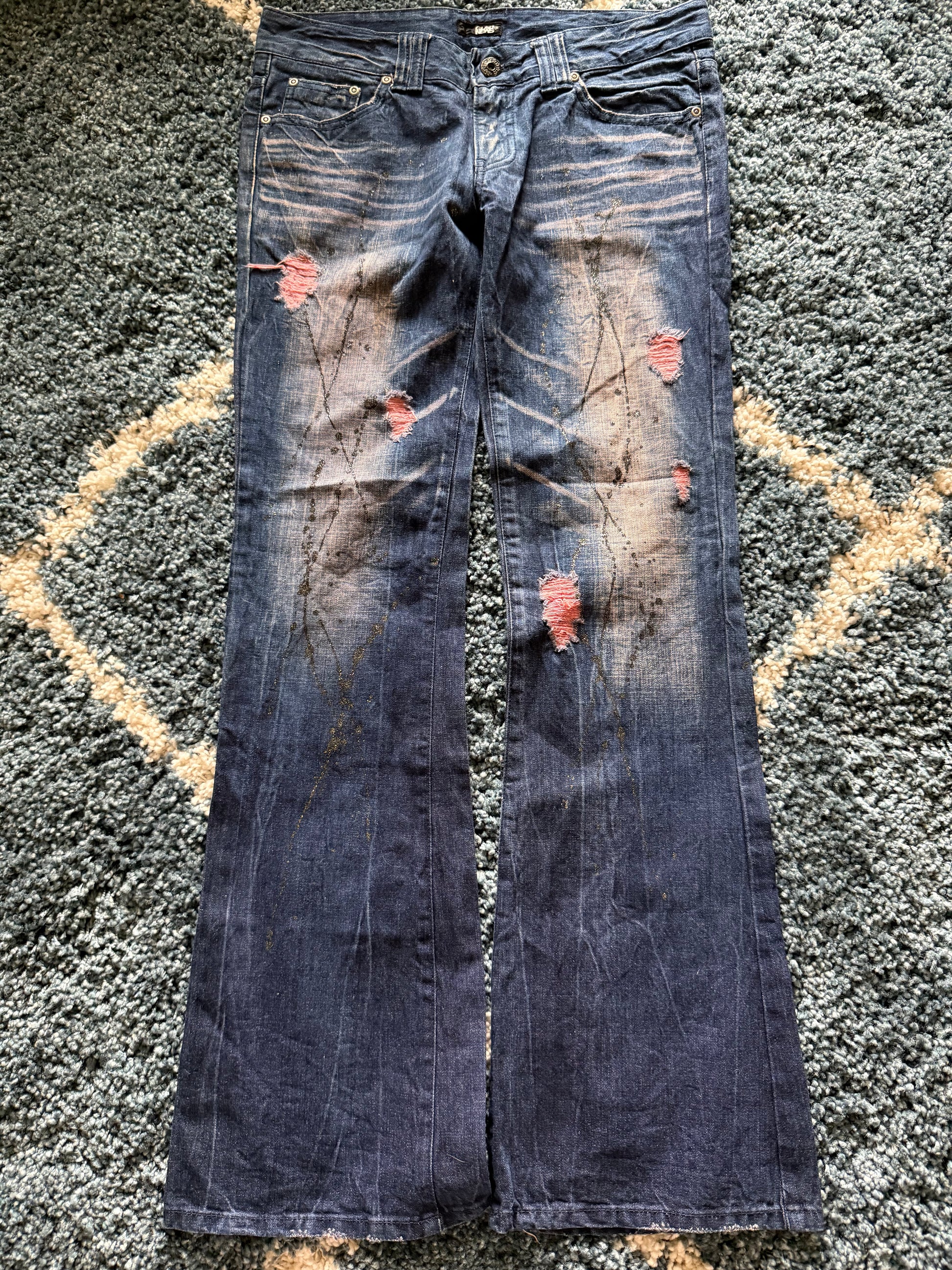 Glad news splattered distressed flared jeans