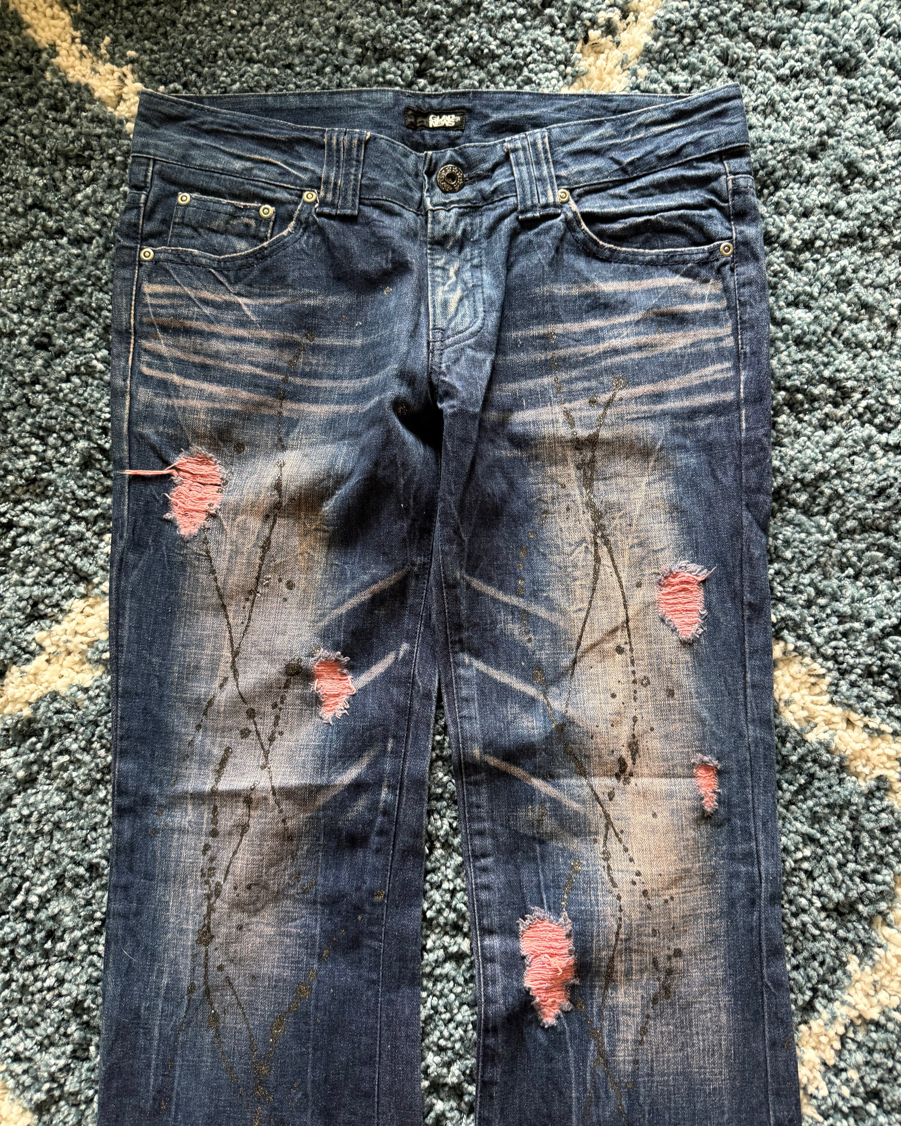 Glad news splattered distressed flared jeans