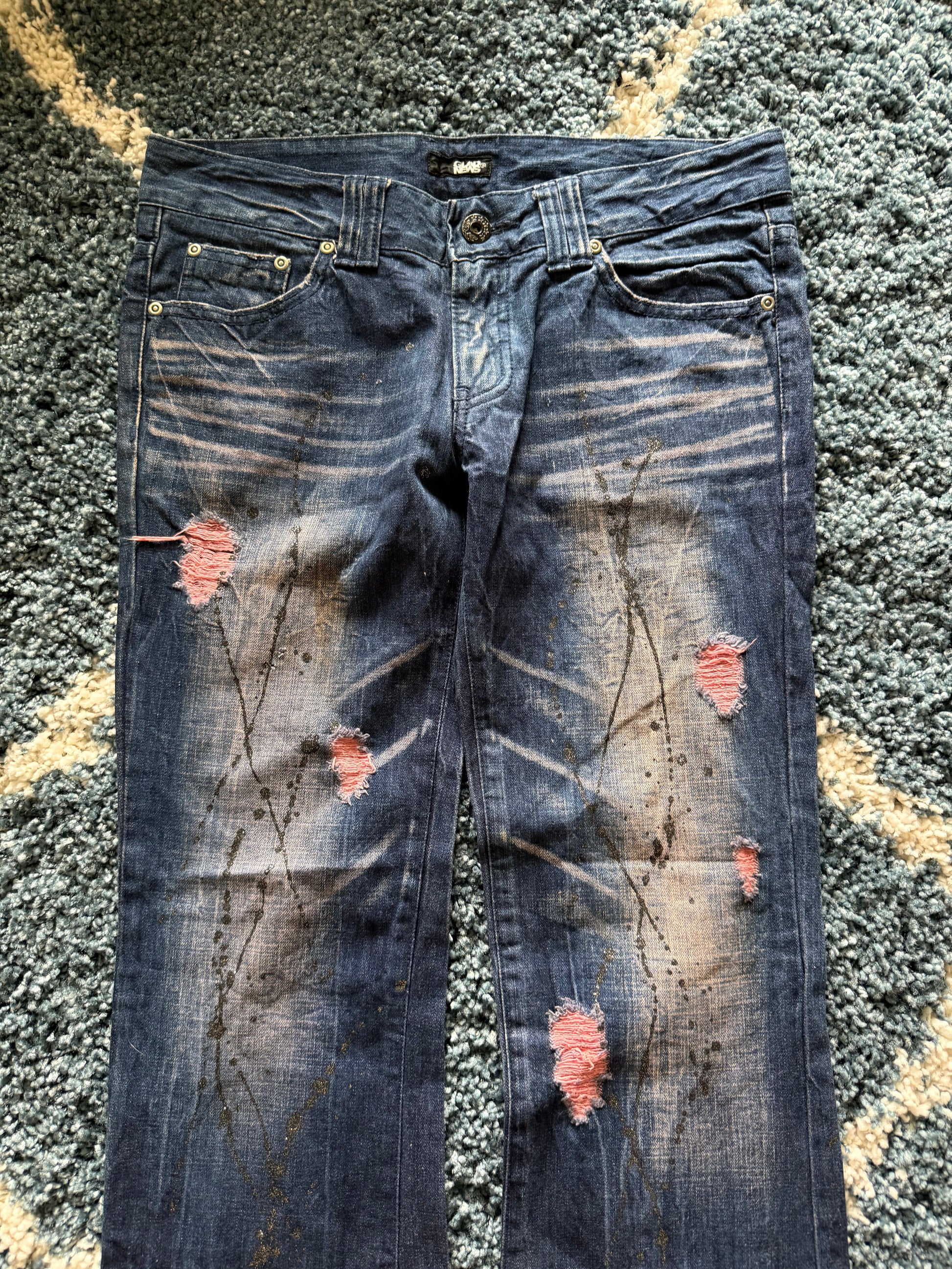 Glad news splattered distressed flared jeans