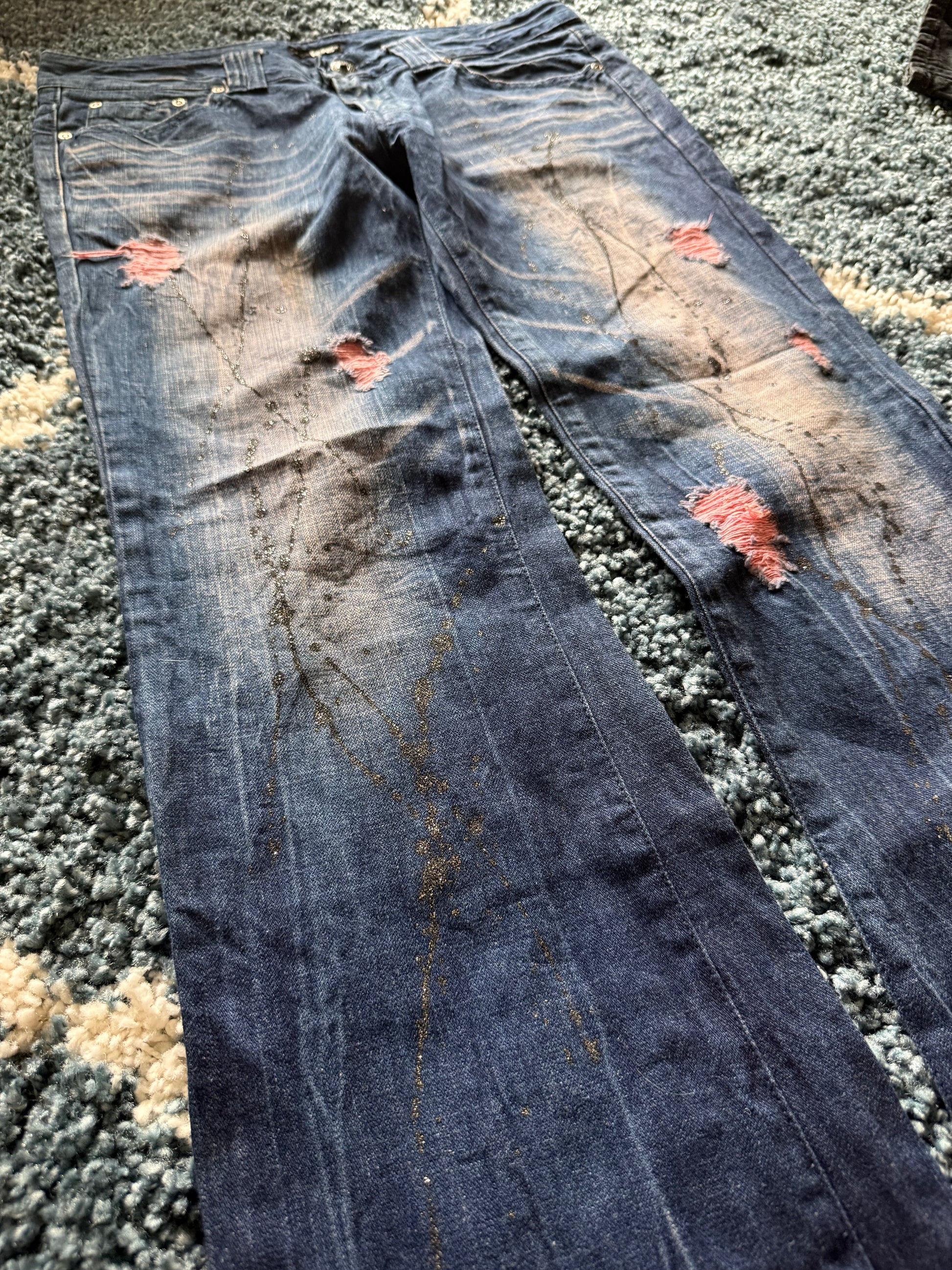 Glad news splattered distressed flared jeans