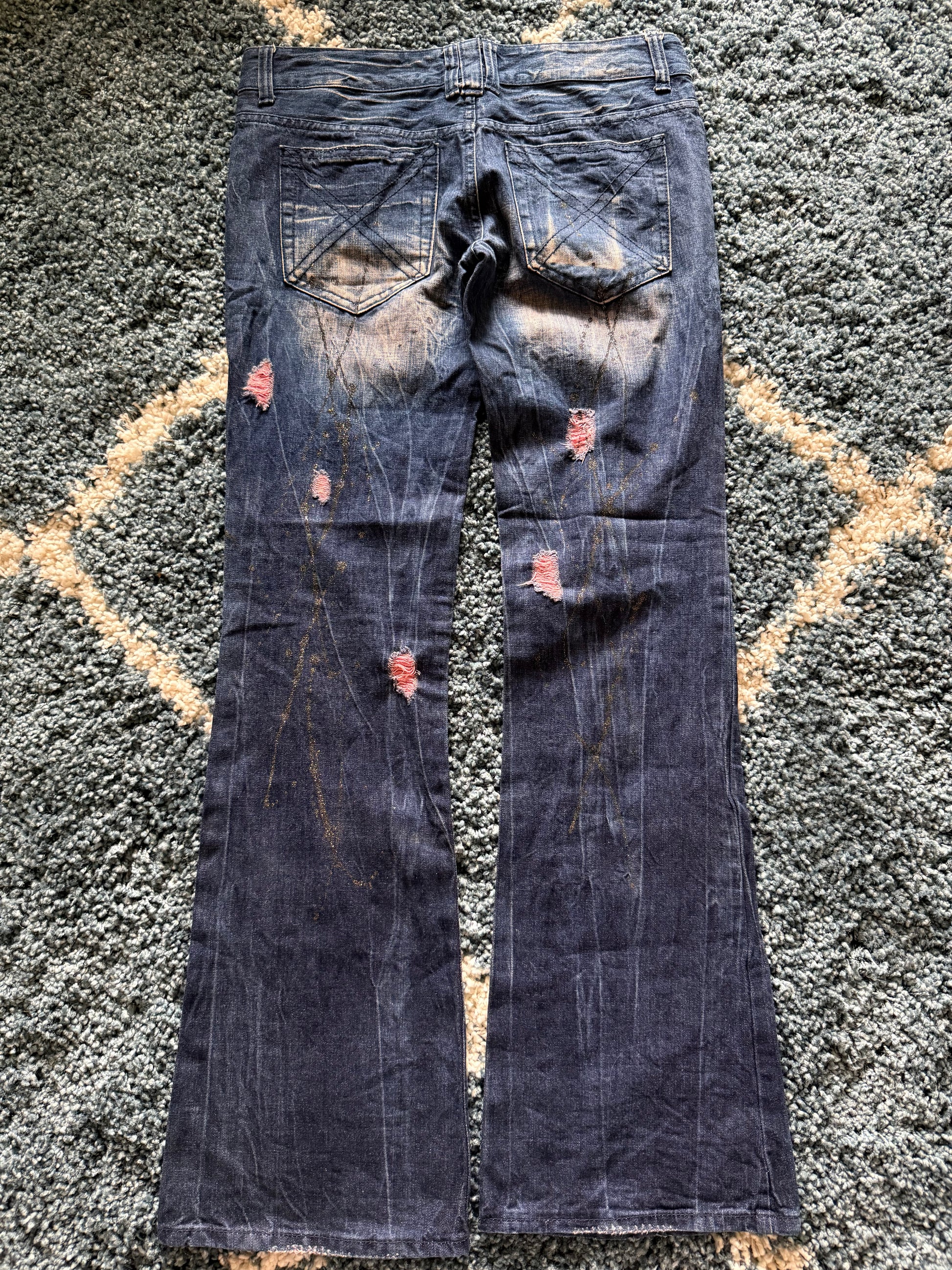Glad news splattered distressed flared jeans