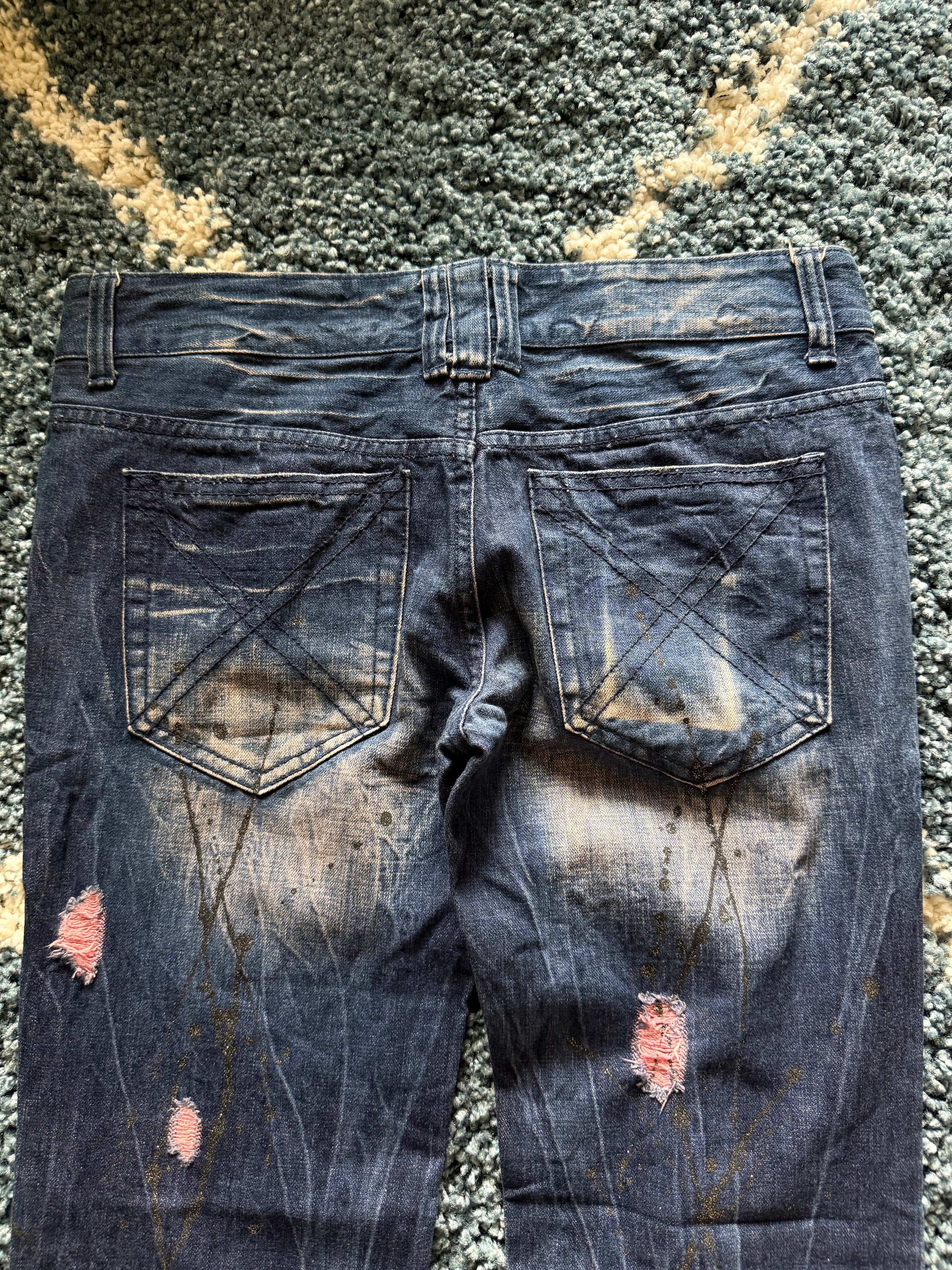 Glad news splattered distressed flared jeans