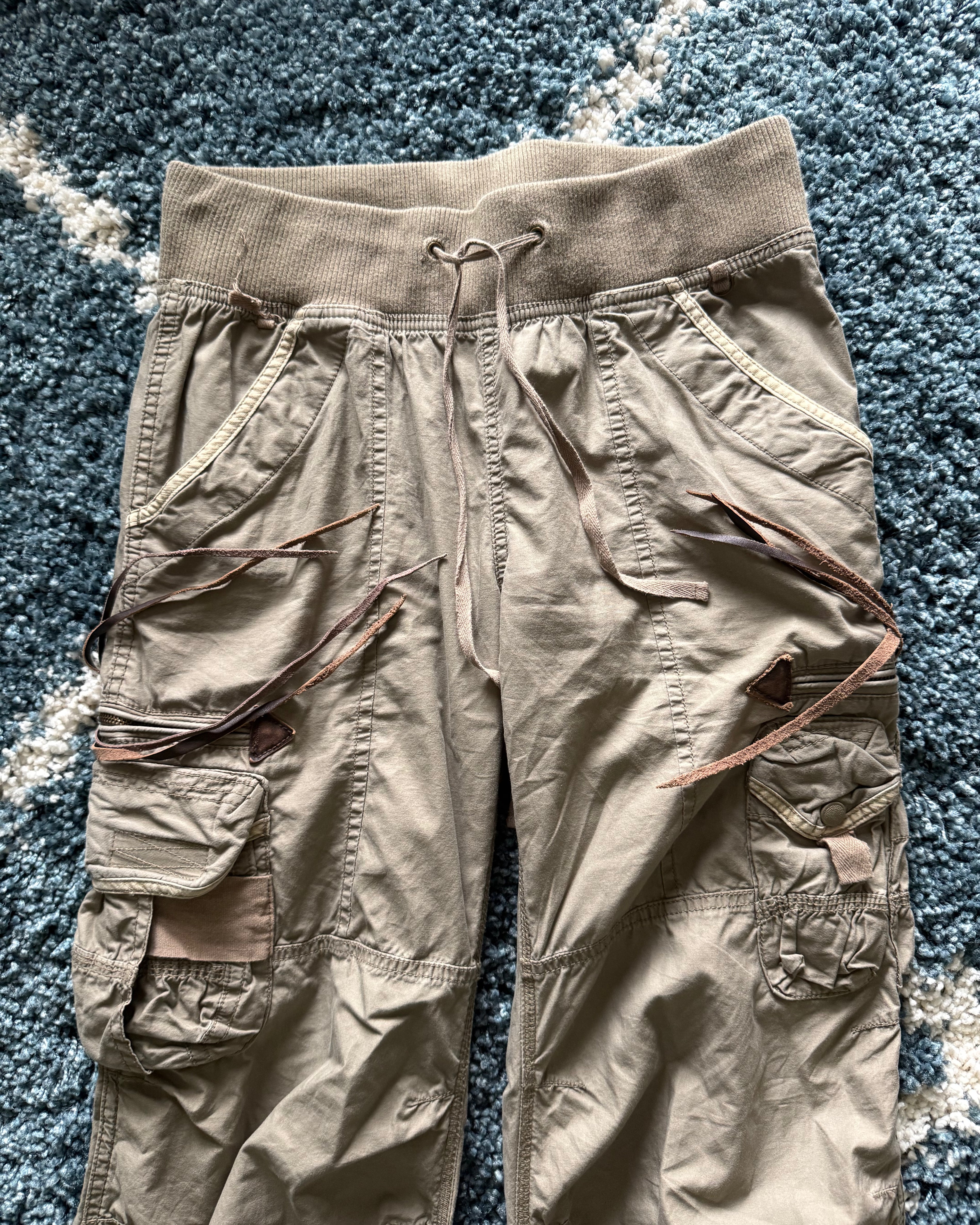 G.O.A leather tasseled mega flared military cargo pants