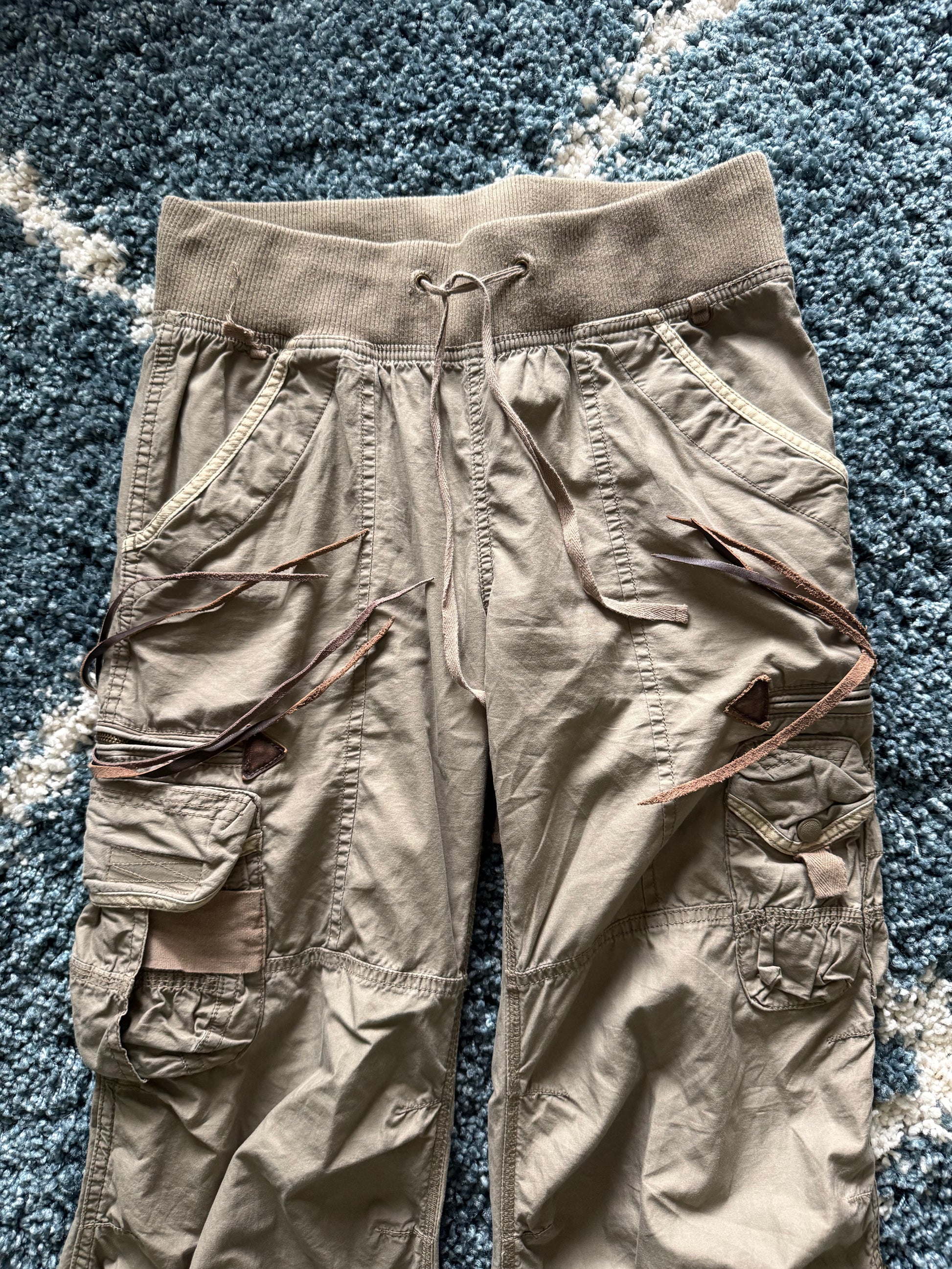 G.O.A leather tasseled mega flared military cargo pants