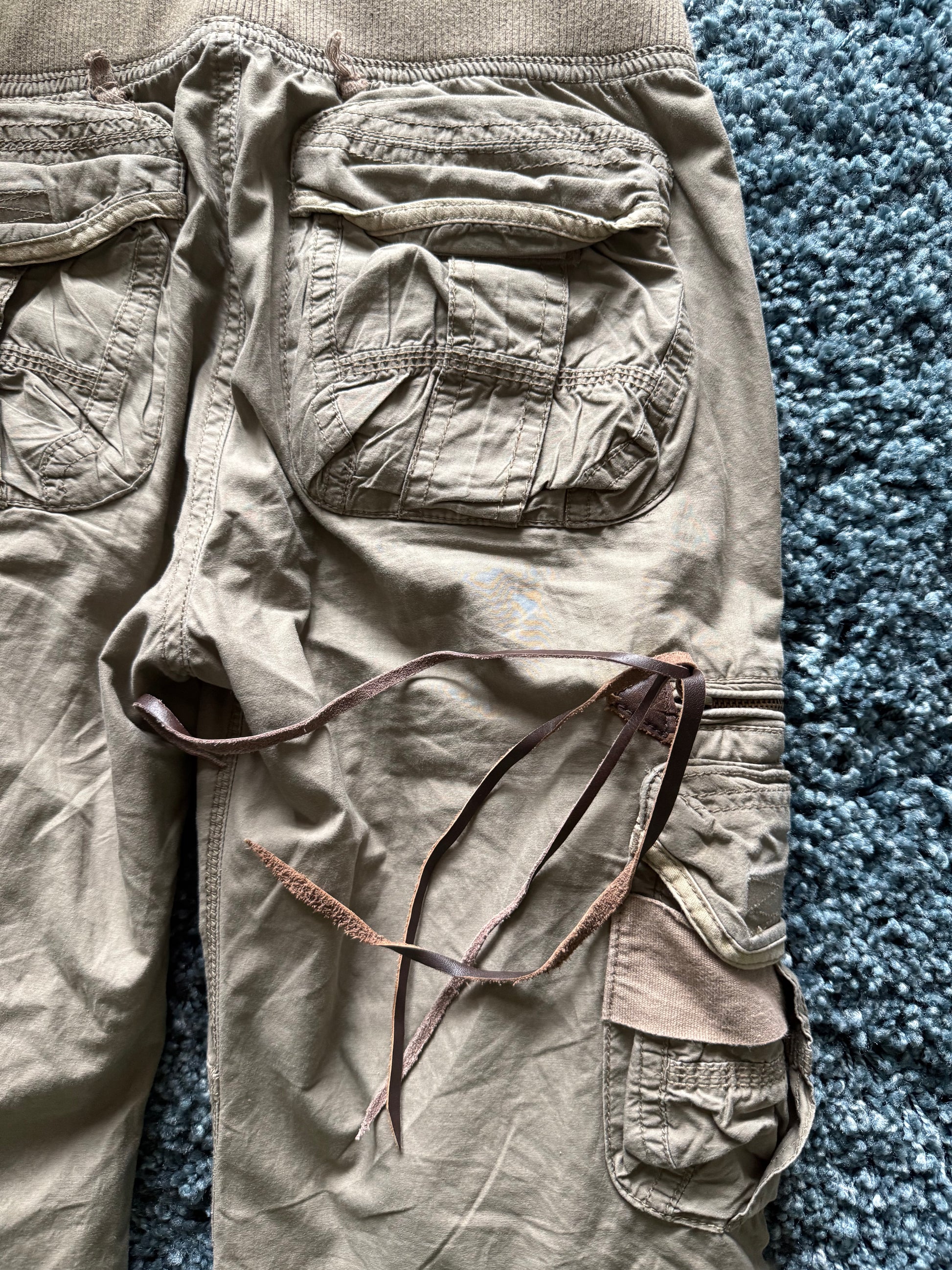 G.O.A leather tasseled mega flared military cargo pants